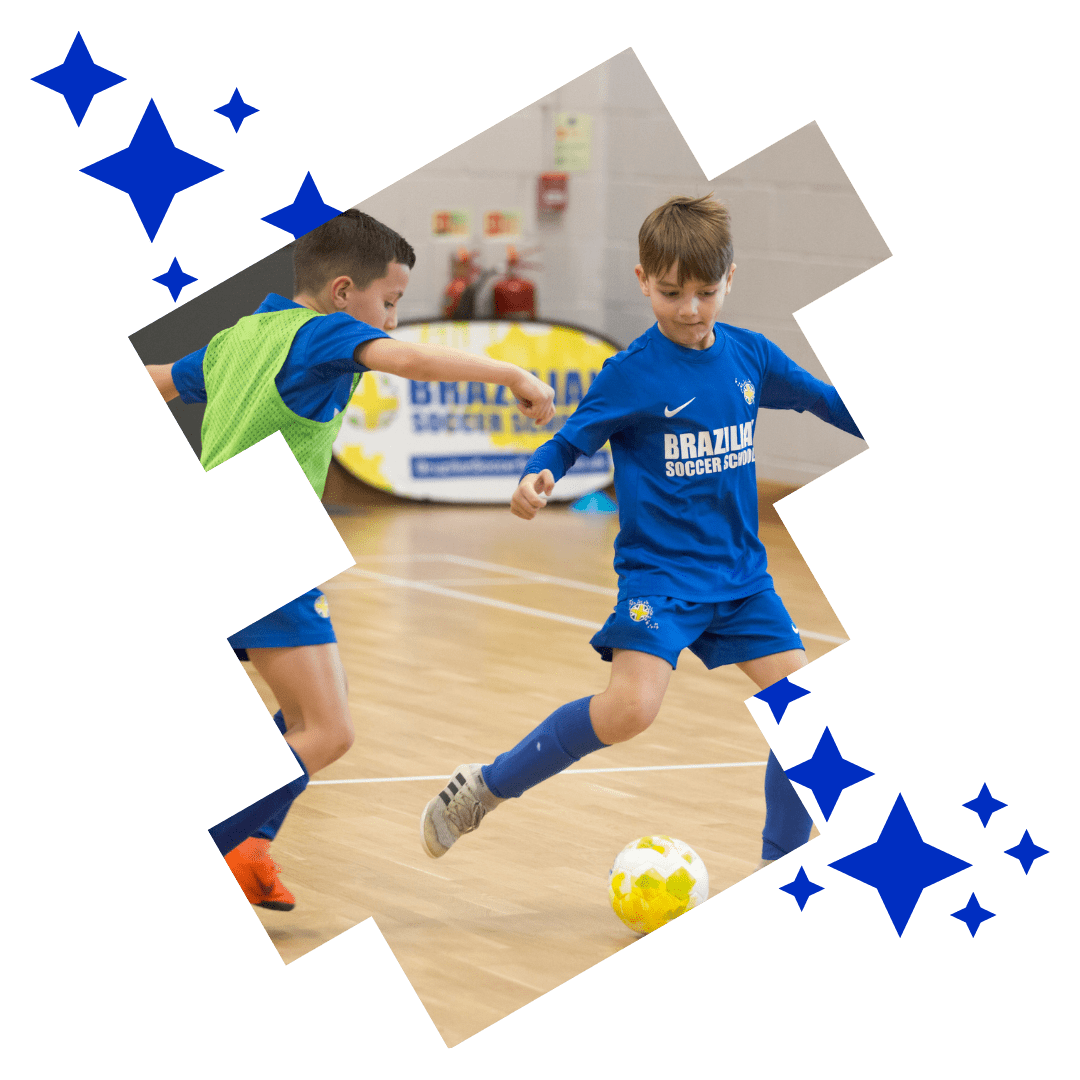 Two players tackling each other at Brazilian Soccer Schools kids football classes Two players tackling each other at Brazilian Soccer Schools kids football classes
