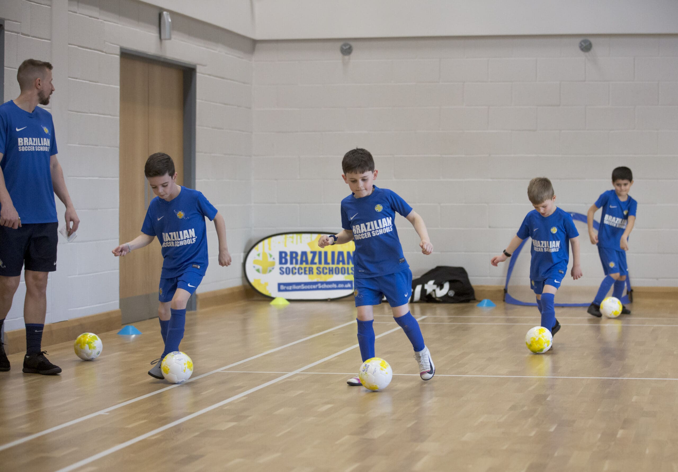 Girl controlling the football while playing at Brazilian Soccer Schools football training classes 