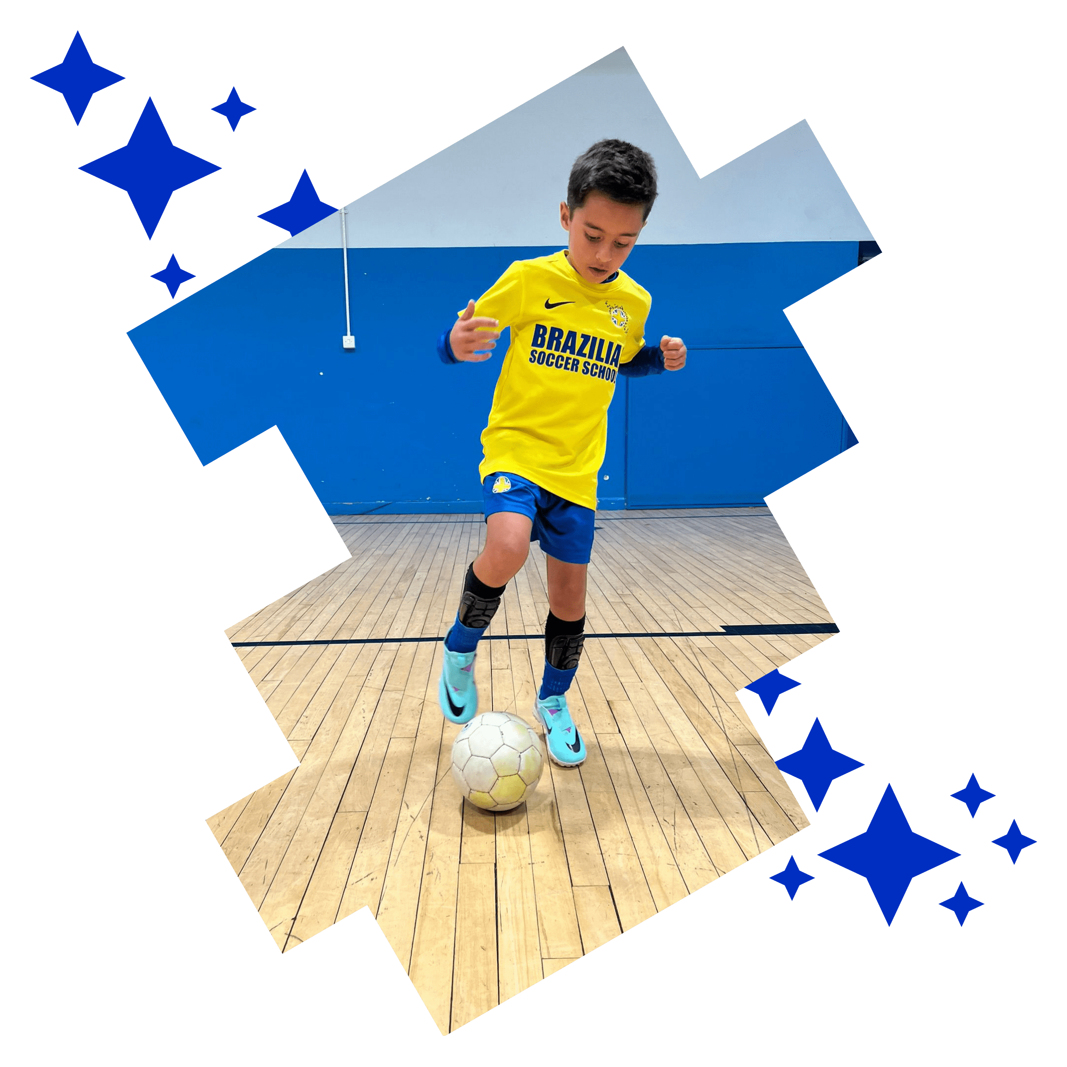 Image shows a Brazilian Soccer Schools student practising toe taps on top of the football.