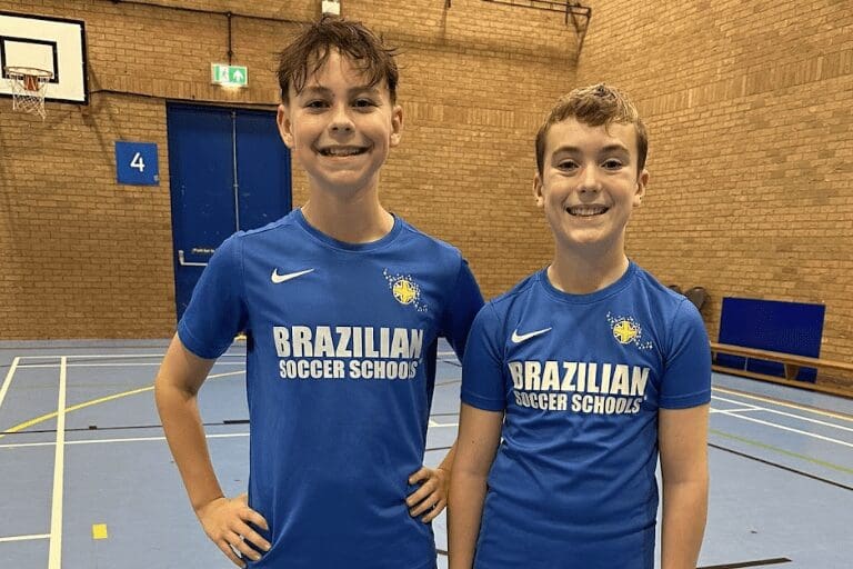 Football classes for kids. Image shows two football players standing in BSS uniform.
