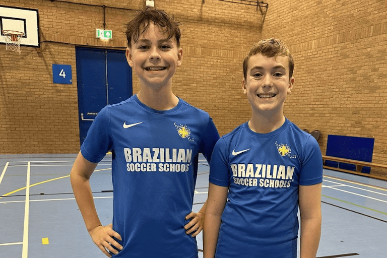 Football classes for kids. Image shows two football players standing in BSS uniform.