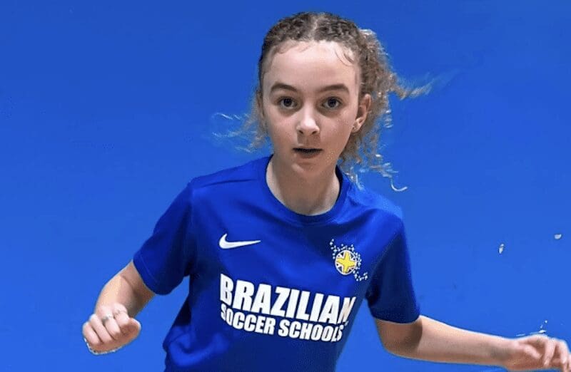 Football classes for kids near me. Image shows a female Brazilian Soccer Schools student in BSS kit.