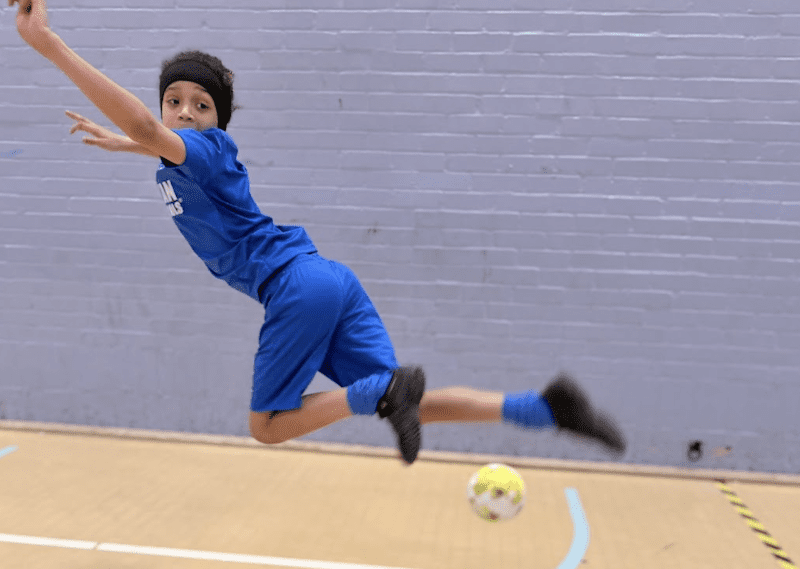 Kids football club Sunderland. Image shows a brazilian soccer schools player jumping in the air doing a trick with a football.